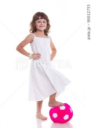Toddler girl in action playing soccer with world globe isolated on white background 90012755