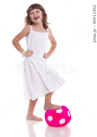 Toddler girl in action playing soccer with world globe isolated on white background 90012902