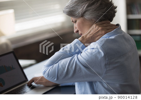 Upset stressed mature woman suffering from neck ache Upset stressed mature woman suffering from neck ache 90014128