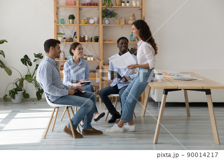 Female mentor and intern sitting in circle on corporate training 90014217