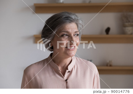 Positive thoughtful senior grey haired lady looking away Positive thoughtful senior grey haired lady looking away 90014776