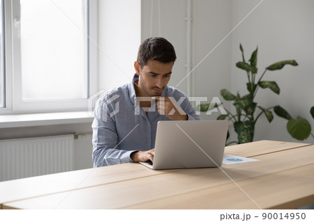 Focused thoughtful freelance worker man thinking over project Focused thoughtful freelance worker man thinking over project 90014950