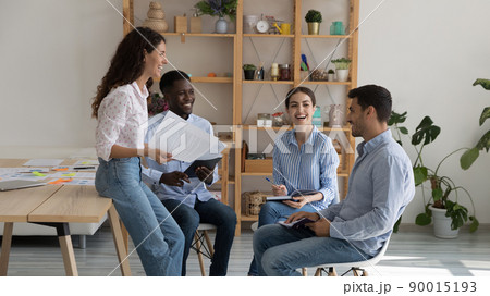 Cheerful excited multiethnic business group brainstorming, sharing funny ideas Cheerful excited multiethnic business group brainstorming, sharing funny ideas 90015193