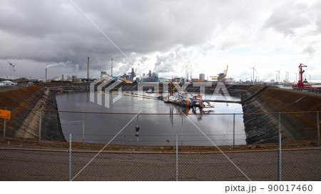 Steel factory plant with chimneys, ship in front 90017460