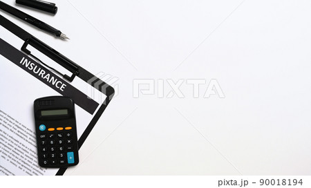 Flat lay insurance claim form on table with calculator and pen. Copy space Flat lay insurance claim form on table with calculator and pen. Copy space 90018194