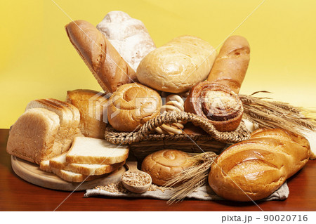Bread with buns,drying bagels,wheat ears on yellow background. Culinary background 90020716