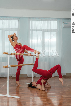 I train with a friend. Two young women train together in a bright training room near a choreographic machine. I train with a friend. Two young women train together in a bright training room near a choreographic machine. 90023393