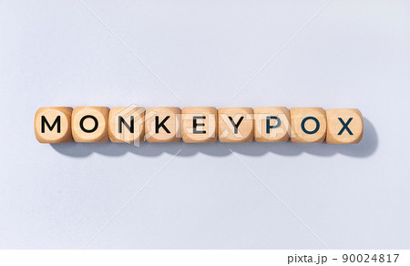Monkeypox word on wooden block isolated on gray background 90024817
