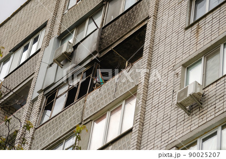 Ukrainian-Russian War 2022. A residential building in Mykolaiv that suffered from Russian army shelling. The balcony of an apartment building without glass. A burned apartment building. Ukrainian-Russian War 2022. A residential building in Mykolaiv that suffered from Russian army shelling. The balcony of an apartment building without glass. A burned apartment building. 90025207