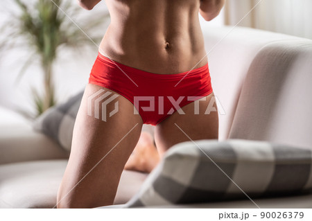 Detail of red menstruation panties on a body of a fit woman Detail of red menstruation panties on a body of a fit woman 90026379