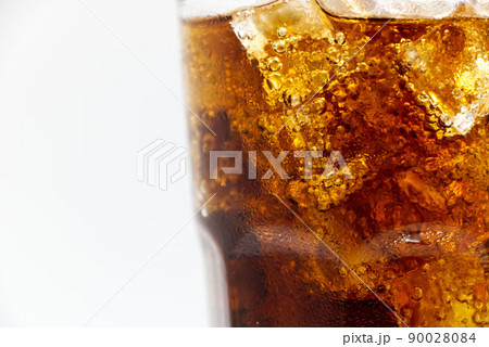Cola glass with crushed on a white background cola ice in glass and there is water droplets around. cool black fresh drink. Cola glass with crushed on a white background cola ice in glass and there is water droplets around. cool black fresh drink. 90028084