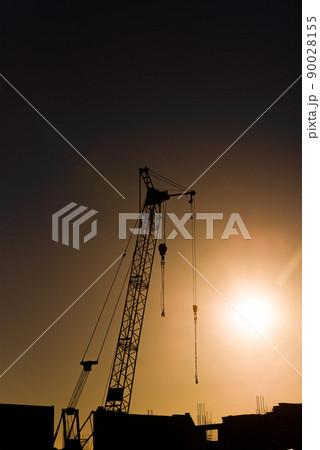 silhouette tower crane of construction site at sunset 90028155