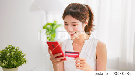 woman online shopping with phone woman online shopping with phone 90030236