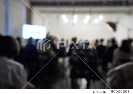 Blurred background of the business conference, a group of people on the stage, presentation of the project, public talk. High quality photo 90030603