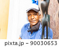 portrait of an afro american carver man in the street 90030653