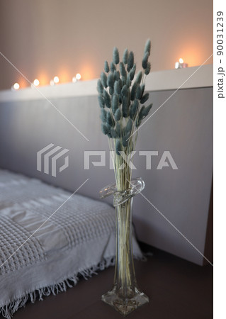 Flowers gray hare tails in glass vase in bedroom Flowers gray hare tails in glass vase in bedroom 90031239
