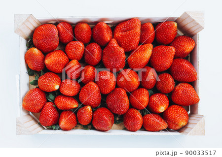 Fresh ripe harvested strawberries in box, top view, closeup 90033517