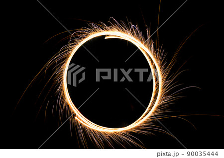 circle drawing light fireworks. Burning flare or flame with bright sparks on background with copy space. long exposure light painting. 90035444