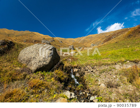 Mountain slope with brook and stones 90035789