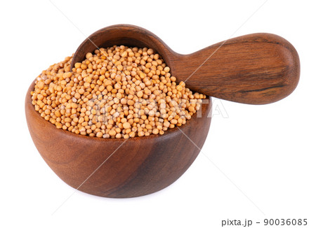 Mustard seeds in wooden bowl and spoon, isolated on white background. Pile of dry mustard grains. 90036085