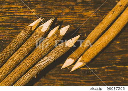 Sharp nature wood pencils on old wooden table in background 90037206