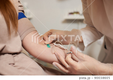 Young woman in blood transfusion concept hand. Young woman in blood transfusion concept hand. 90038605