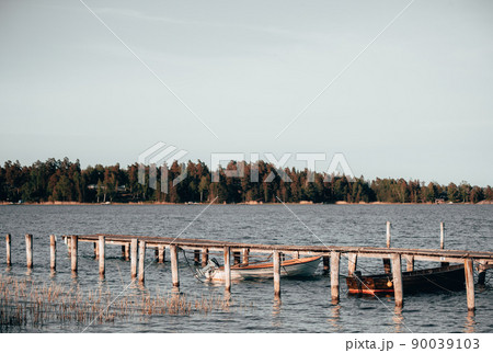 Skiffs at a jetty on a sunny day 90039103