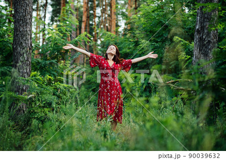 Connecting with nature benefits mental health. Nature Therapy Ecotherapy Helps Mental Health. Nature Impact Wellbeing. Woman in red dress enjoying nature 90039632