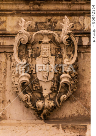 Stone ancient heraldic coat of arms on the wall Stone ancient heraldic coat of arms on the wall 90042554