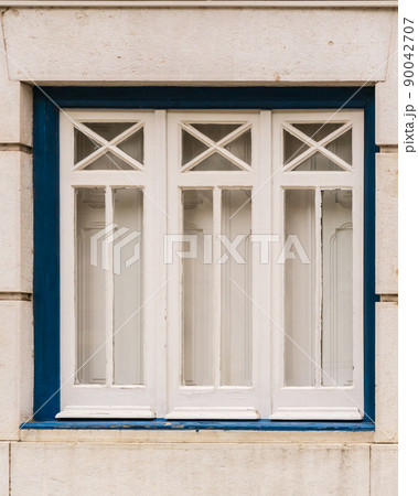 Beautiful white window with closed shutters 90042707