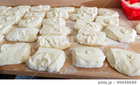 Portioned pieces of dough prepared for shaping in bakery 90048689