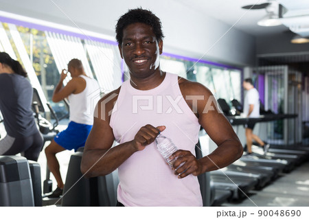 Man resting after workout with still water 90048690