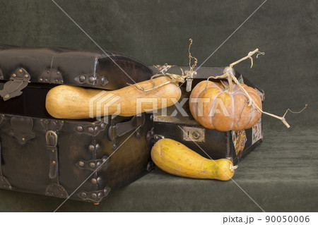 An old suitcase and a chest with pumpkins 90050006