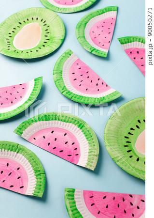 Fruit made of paper - watermelon. Blue background. Tropics creative concept, kindergarten, daycare handmade papercraft, summer season, sweet food. Flat lay. 90050271