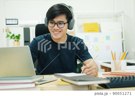 Young man study in front of the laptop computer at home Young man study in front of the laptop computer at home 90051271