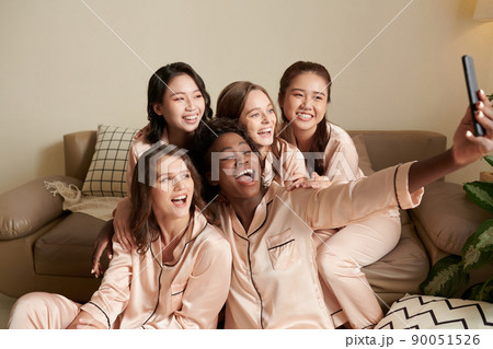 Friends in Pajams Taking Selfie Friends in Pajams Taking Selfie 90051526