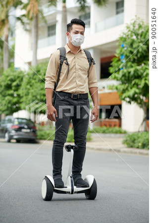 Man Riding on Personal Transporter Man Riding on Personal Transporter 90051640