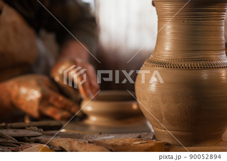 Potter working a piece of clay Potter working a piece of clay 90052894