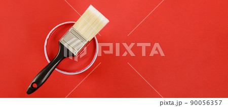 The cans of interior wall paint is placed on a red background. The cans of interior wall paint is placed on a red background. 90056357