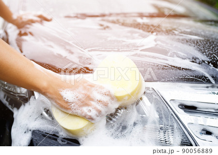 people worker man holding hand yellow sponge and bubble foam cleanser window for washing car. Concept car wash clean. Leave space for writing messages. people worker man holding hand yellow sponge and bubble foam cleanser window for washing car. Concept car wash clean. Leave space for writing messages. 90056889