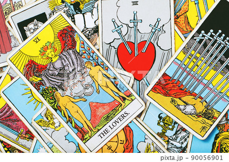 A pile deck of Tarot cards gypsy inspired on a wooden background scattered and haphazardly arranged. Fortune teller, Magician, wizard. Horoscope.. 90056901