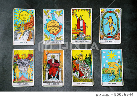 A pile deck of Tarot cards gypsy inspired on a wooden background scattered and haphazardly arranged. Fortune teller, Magician, wizard. Horoscope.. A pile deck of Tarot cards gypsy inspired on a wooden background scattered and haphazardly arranged. Fortune teller, Magician, wizard. Horoscope.. 90056944