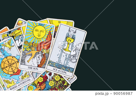A pile deck of Tarot cards gypsy inspired on a wooden background scattered and haphazardly arranged. Fortune teller, Magician, wizard. Horoscope.. A pile deck of Tarot cards gypsy inspired on a wooden background scattered and haphazardly arranged. Fortune teller, Magician, wizard. Horoscope.. 90056987