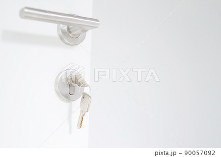 house key on home shaped key chain silver keyring in the unlock open of a door. concept for buying real estate agent housing and apartment. house key on home shaped key chain silver keyring in the unlock open of a door. concept for buying real estate agent housing and apartment. 90057092