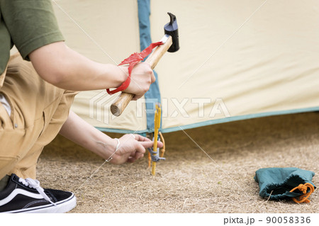 テント設営をする若い女性手元 90058336