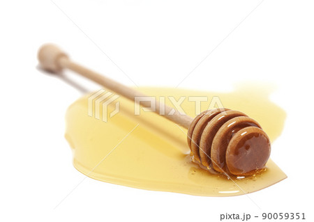 Wooden dipper with honey isolated on a white background. Golden organic floral honey natural. Wooden dipper with honey isolated on a white background. Golden organic floral honey natural. 90059351