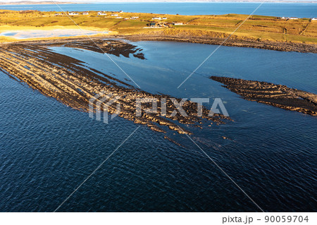 Aerial view of the amazing coast at St Johns Point next to Portned Island in County Donegal - Ireland. Aerial view of the amazing coast at St Johns Point next to Portned Island in County Donegal - Ireland. 90059704