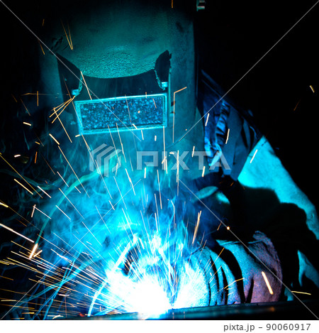 Welder uses torch to make sparks during manufacture of metal equipment Welder uses torch to make sparks during manufacture of metal equipment 90060917