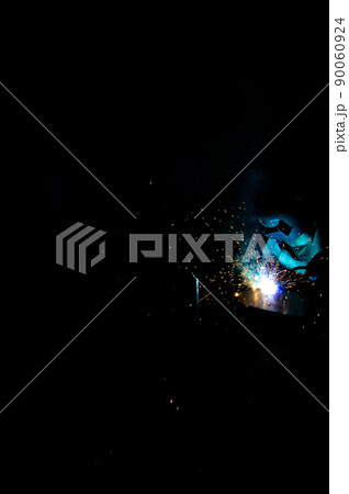 Welder uses torch to make sparks during manufacture of metal equipment Welder uses torch to make sparks during manufacture of metal equipment 90060924