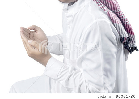 Muslim man with keffiyeh with agal raised hands and praying 90061730